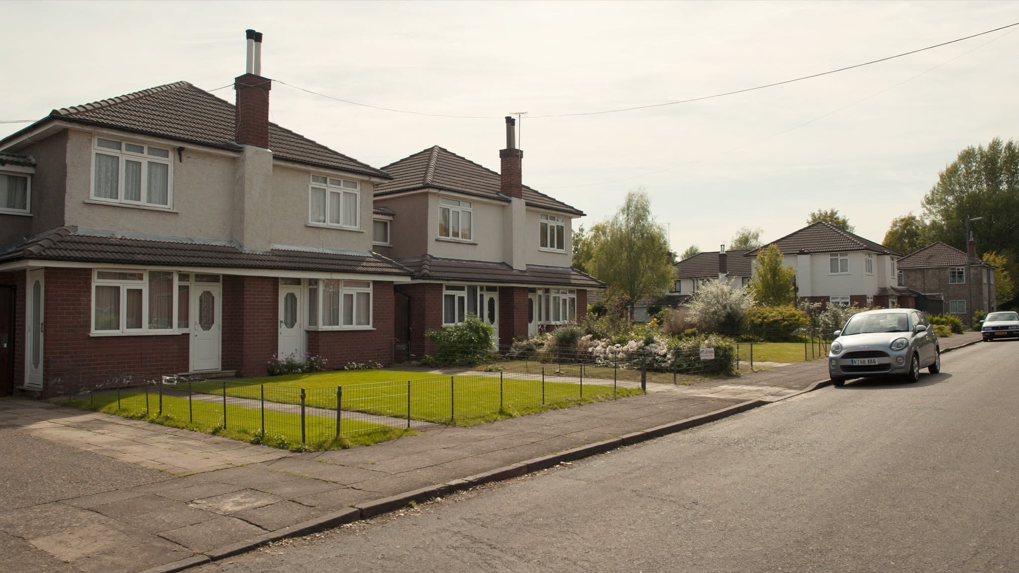 A row of ex council semi detached houses along a quiet residential street