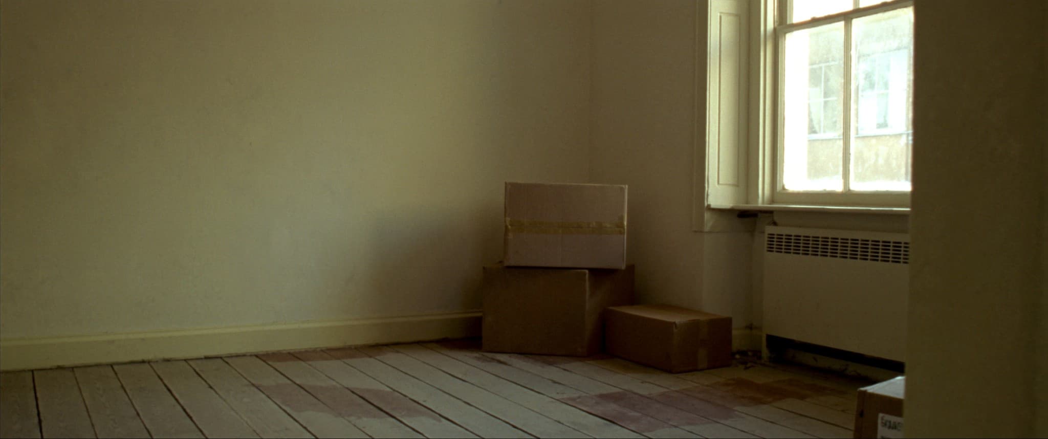 A first flat, empty but for boxes still taped shut.