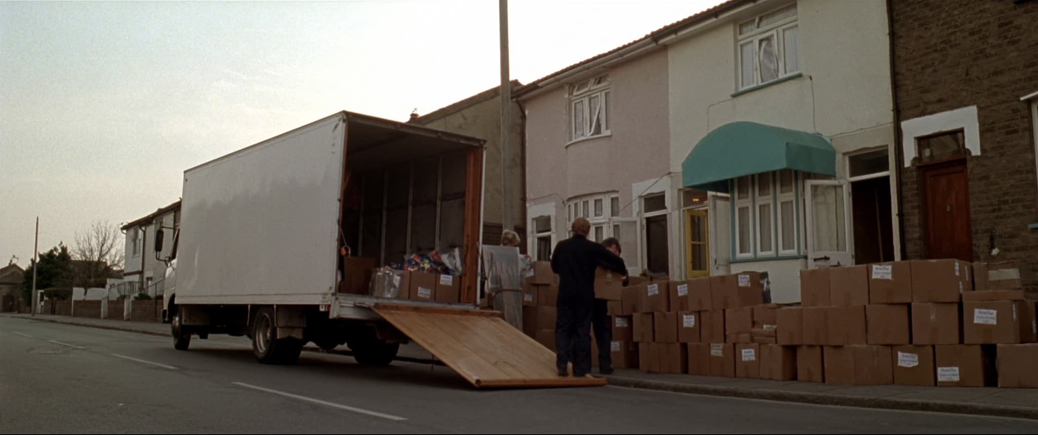 A removals van backed up to a terraced house on moving morning.