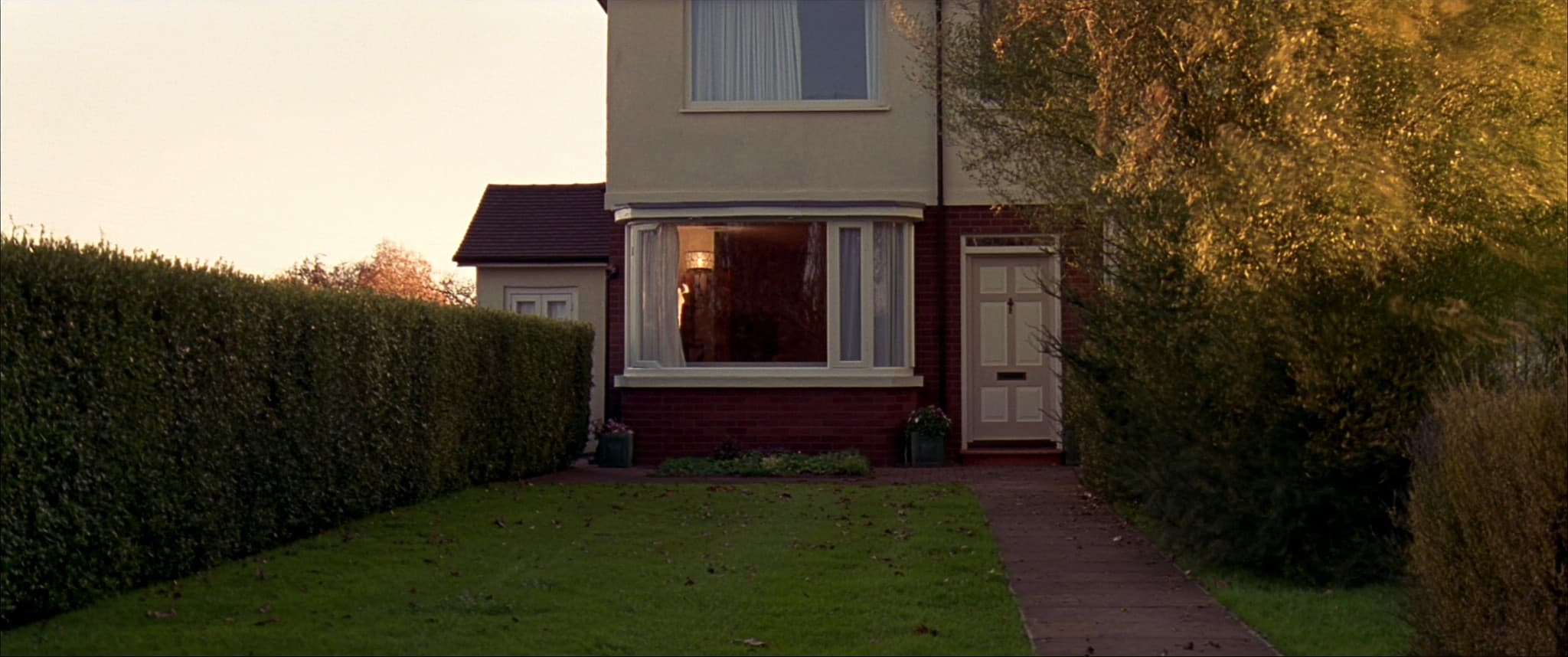 A front garden and path seen from the pavement, the house ready to show.