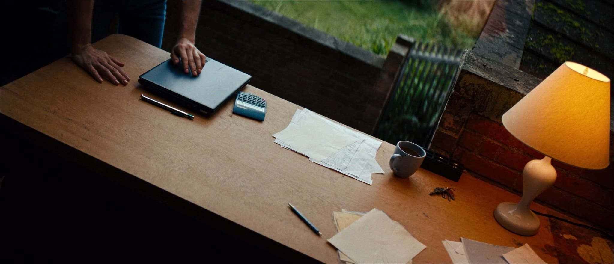 A couple at a table with a laptop and moving costs written out, working out the total