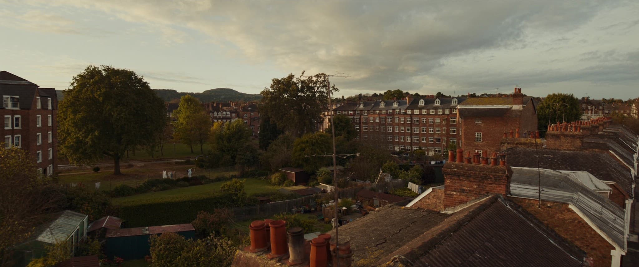 An elevated view across the rooftops and gardens of a mixed UK residential neighbourhood